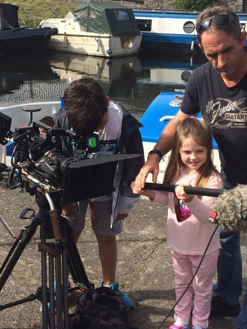 Young performers learning the ropes behind a professional camera on location