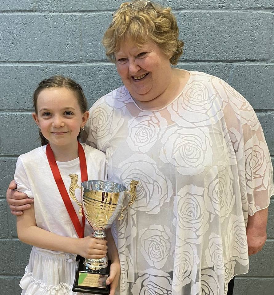 A student receiving an award with a Stage Door & More teacher