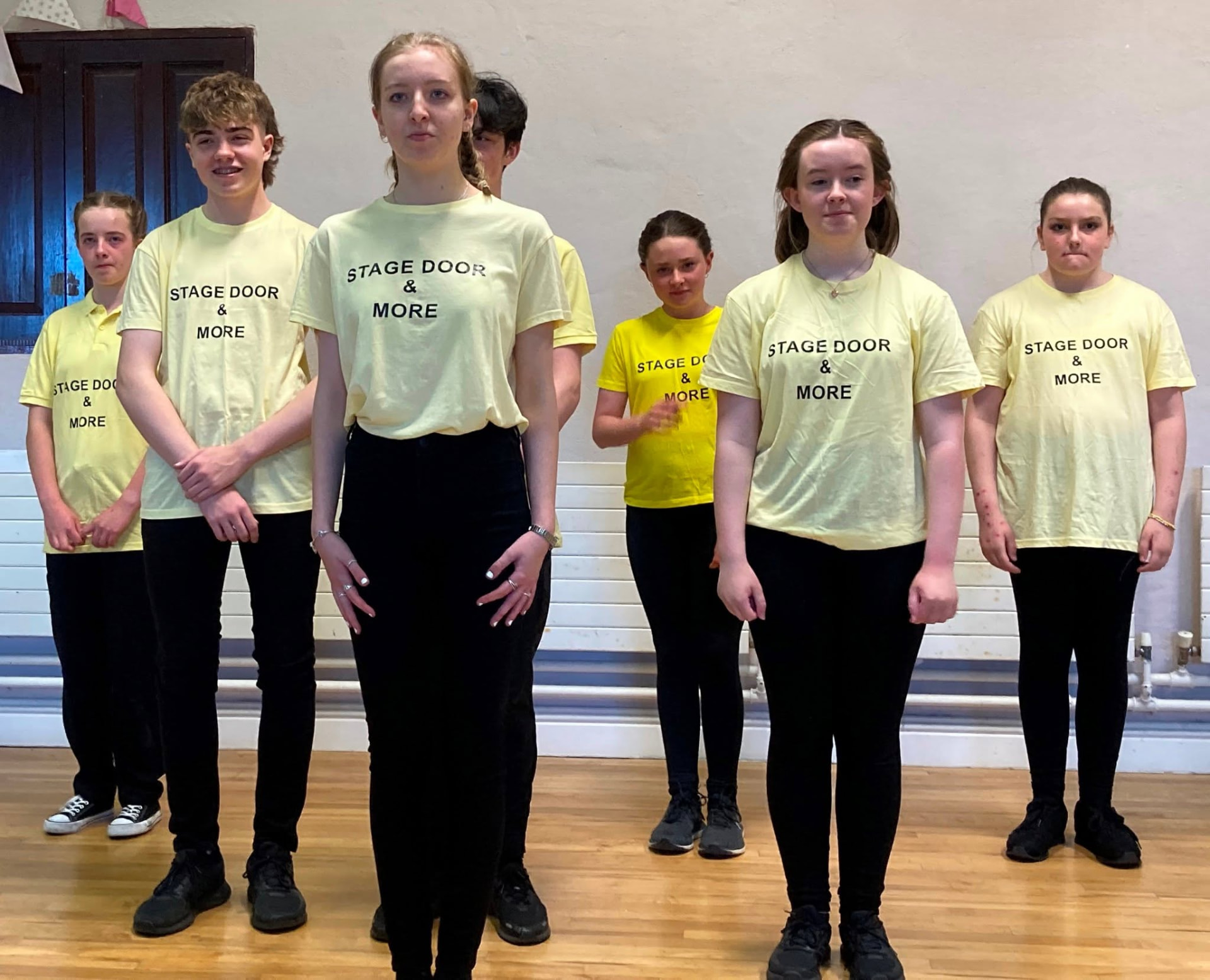 Students wearing Stage Door & More t-shirts ready for class